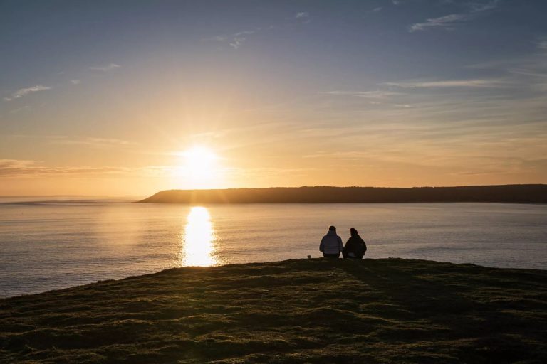 People Watching Sunset At Rhossili Bay, Worm's Head, Gower Peninsula
