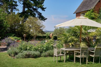 The garden and outdoor dining area at The Coach House, Cotswolds