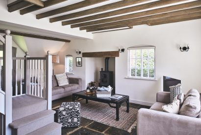The living room with a log burner at The Coach House, Cotswolds