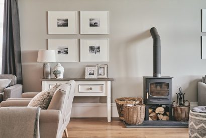 The living room with log burner at Peak Farmhouse, Anglesey