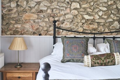 The bed and side table at Blackdown Cottage, Devon