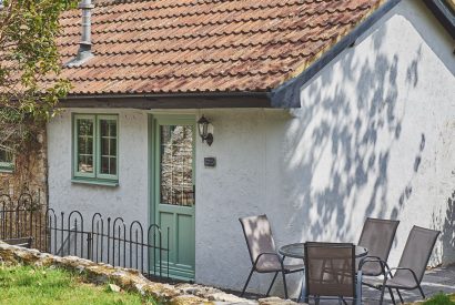 The exterior and outdoor dining area at Half Moon Cottage, Devon