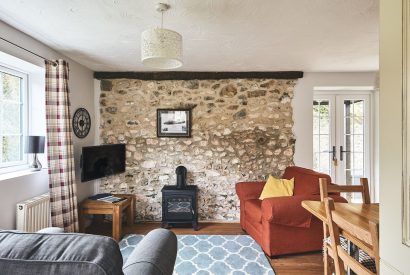 The living room with log burner at Harcombe Cottage, Devon