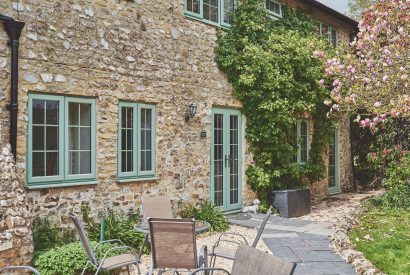 The exterior and outdoor dining area at Millthorn Cottage, Devon