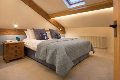 A bedroom with beams at Thresher's Cottage, Lake District