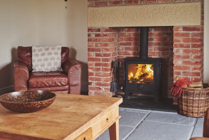 The fire place with log burner at Curlew Cottage, Peak District