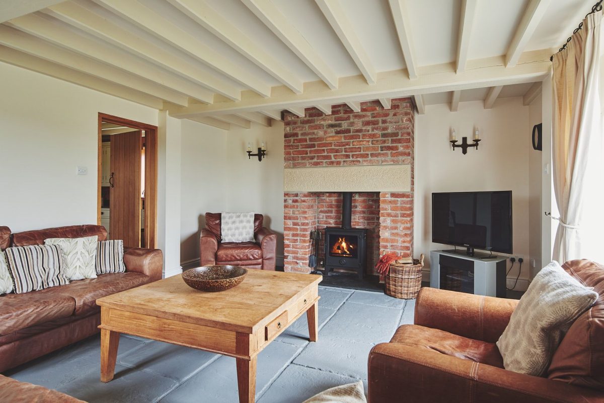 The living room with fireplace at Curlew Cottage, Peak District