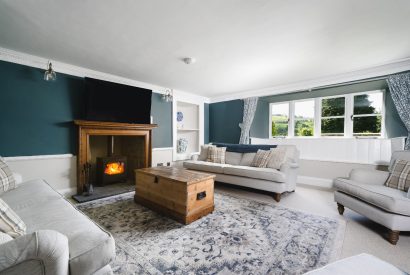 The living room with log burner at Holwell Farmhouse, Devon