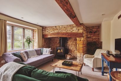The living room with log burner at Church View Cottage, Cotswolds