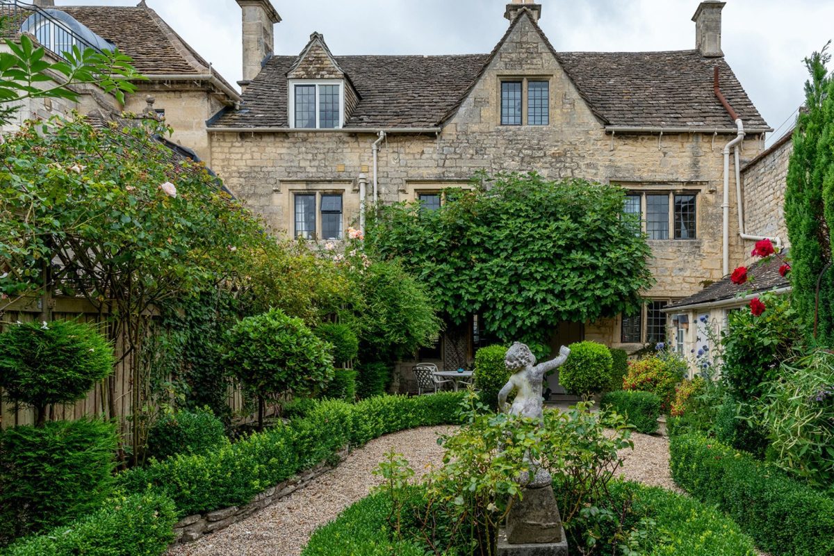 The exterior of the cottage and private rose garden at Fig Tree Cottage, Cotswolds 