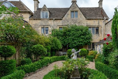 The exterior of the cottage and private rose garden at Fig Tree Cottage, Cotswolds 