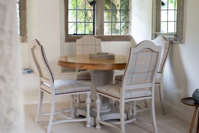 The four-seater dining table and chairs in the reception room at Fig Tree Cottage, Cotswolds