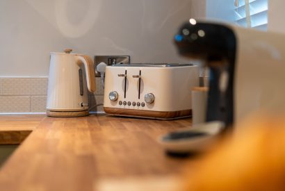 The coffee machine, toaster and kettle on the kitchen counter at Pilgrim Cottage, Cheshire