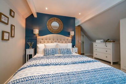 The master bedroom with a double bed at Pilgrim Cottage, Cheshire