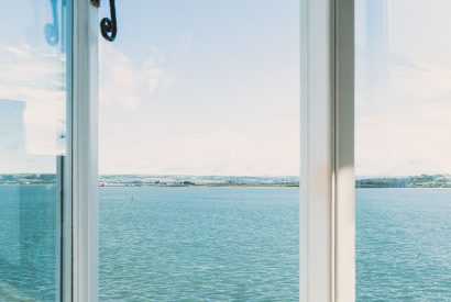 Views of the estuary in the master bedroom at Waters Dream, Devon