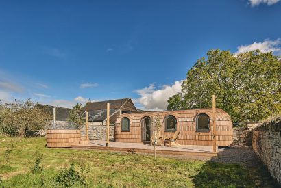 The exterior and hot tub of the igluhut at Orchard Snug, Somerset