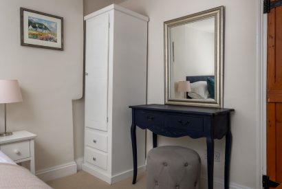 A bedroom with a dressing table at Upper Cottage, Cotswolds