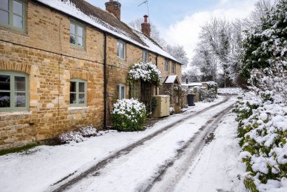 The snowy lane and exterior of Upper Cottage, Cotswolds