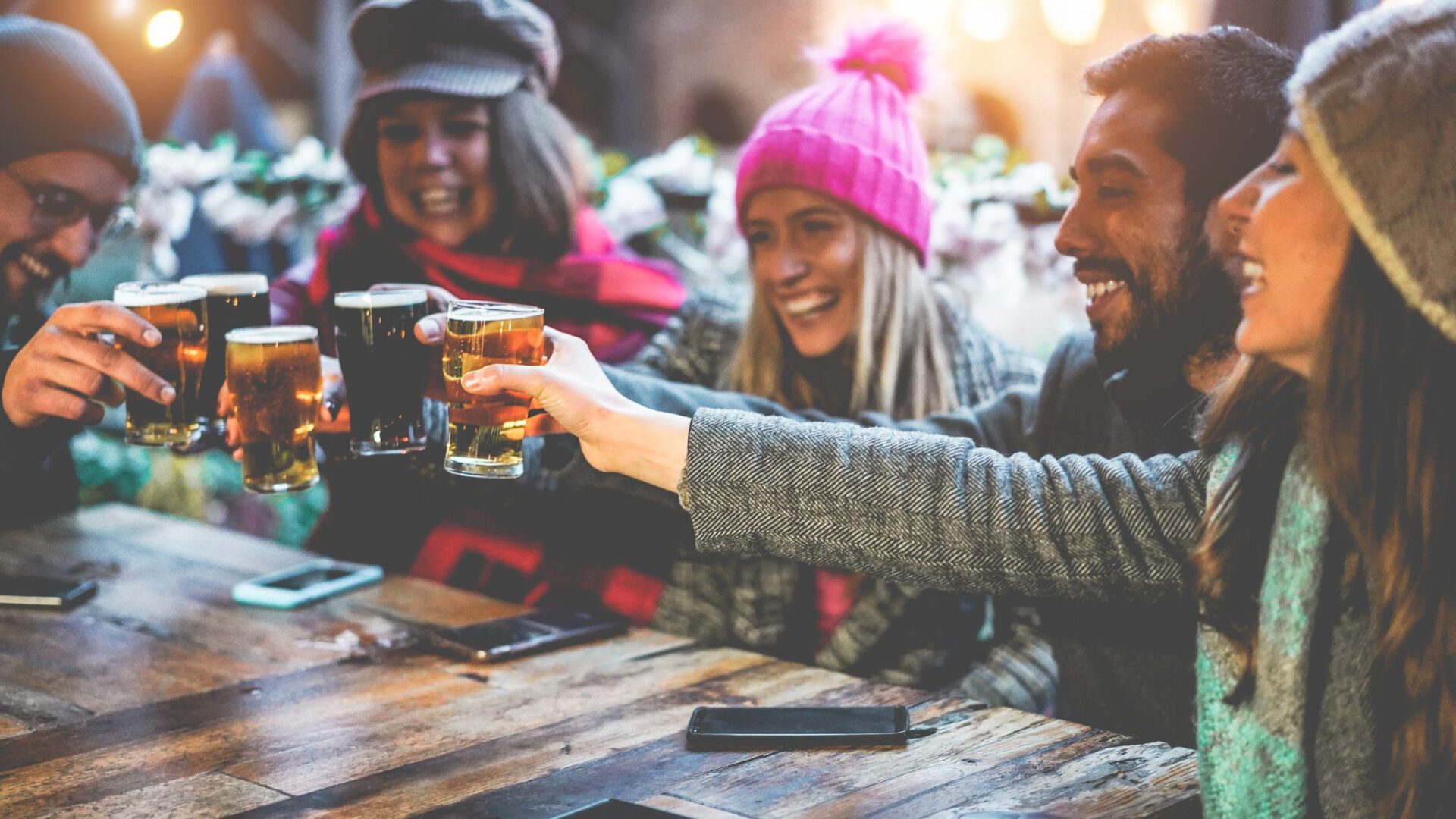 Group Of Happy Friends Drinking And Toasting Beer At Brewery Bar