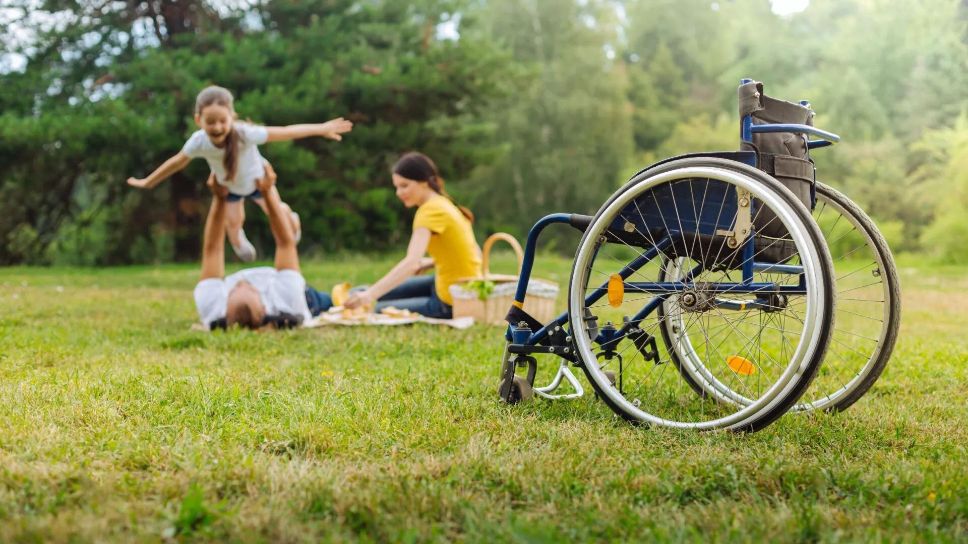 Disabled Man Lifting Up His Daughter On Picnic