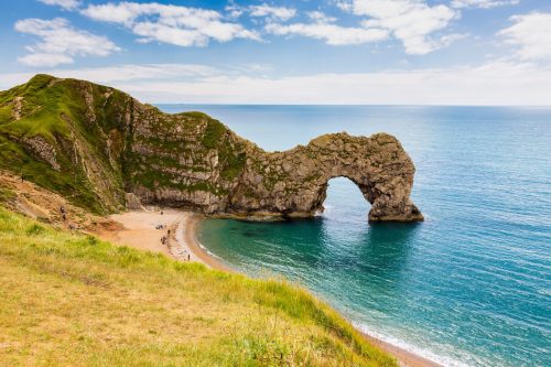Durdle Door rock formation in the sea off a beautiful beach in Dorset