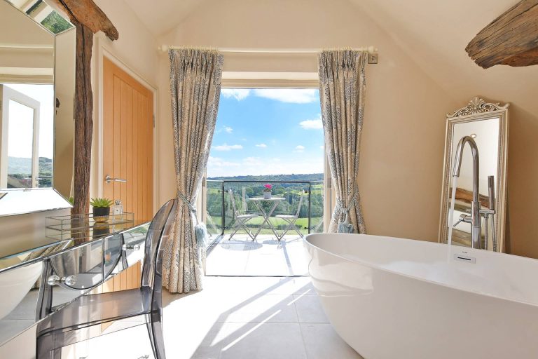 bath with views onto the balcony and countryside