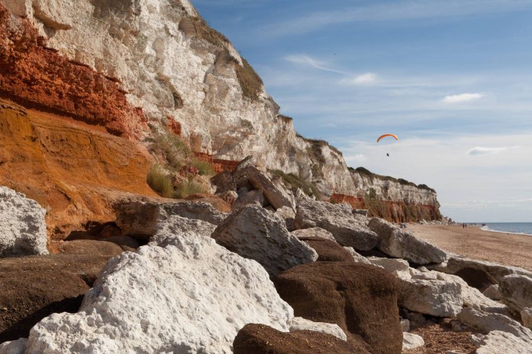 Cliffside in Hunstanton with a person paragliding