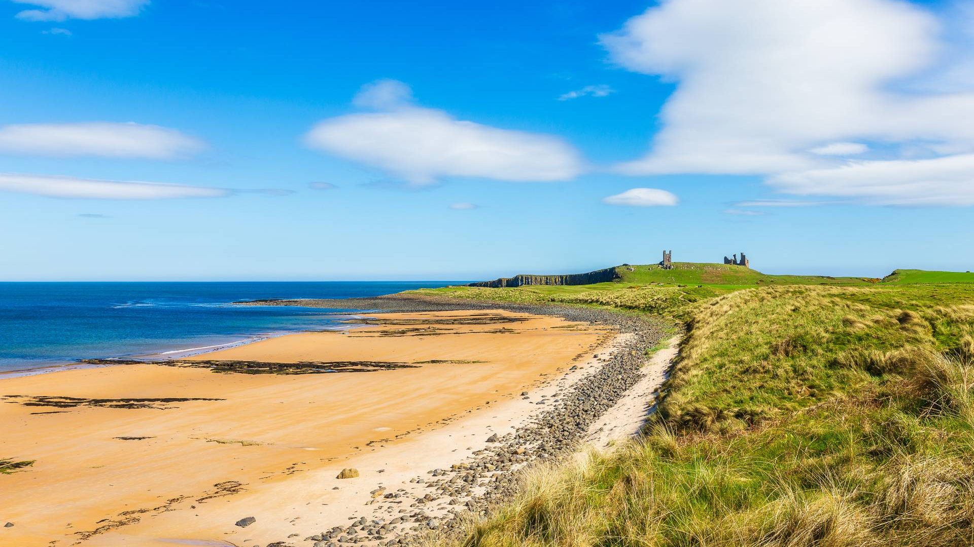 The Beach At Dunstanburg Castle In Northumberland, England