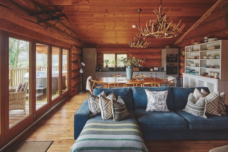 The lounge/diner of River Cabin in Cumbria decorated in a cosy Scandi style