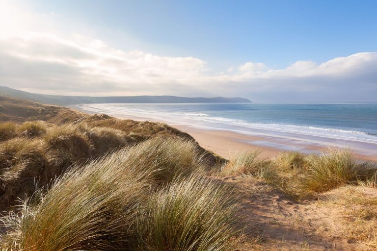 View on a sunny day over the sand dunes to the beach and sea at Woolacombe in Devon