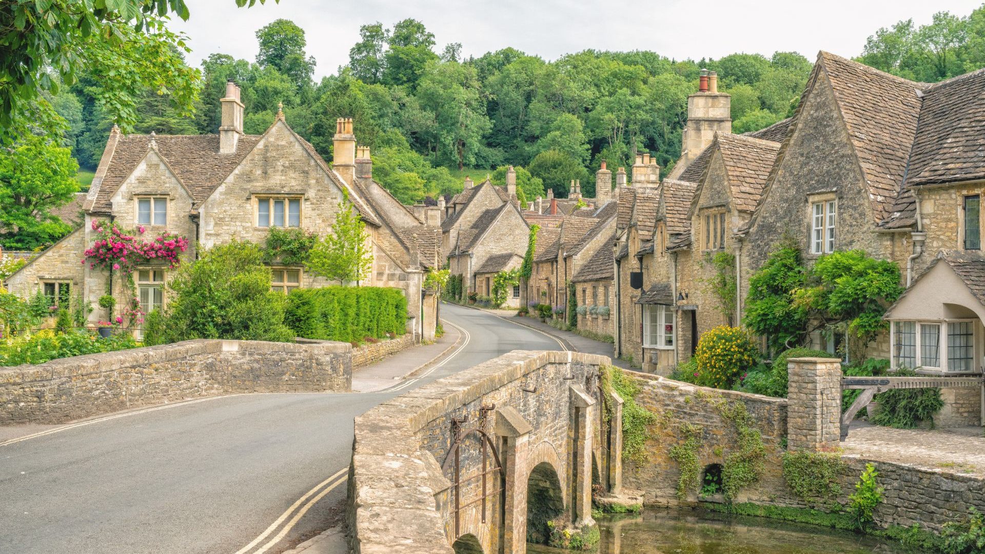Village of Castle Combe in the Cotswolds, Wiltshire, UK. Bridge over River Bybrook