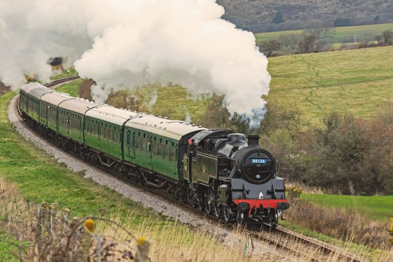 Steam Train Moving Through The Countryside In The UK