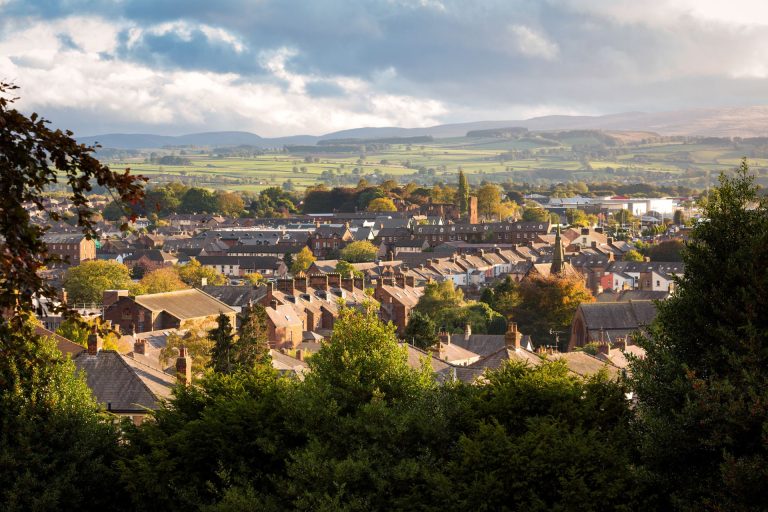 Town Of Penrith In Cumbria With Hills In Background