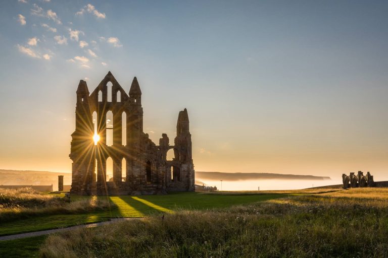 A view of Whitby Abbey at sunset
