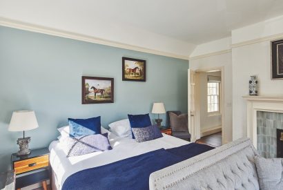 A bedroom with fireplace at Equestrian Manor, Malvern Hills