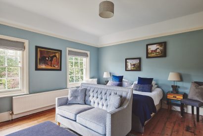A bedroom with a sofa at Equestrian Manor, Malvern Hills