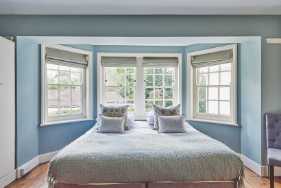 A bedroom with bay windows at Equestrian Manor, Malvern Hills