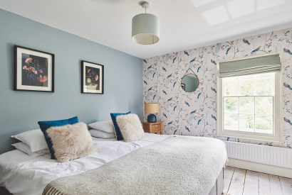 A bedroom with blue wallpaper at Equestrian Manor, Malvern Hills