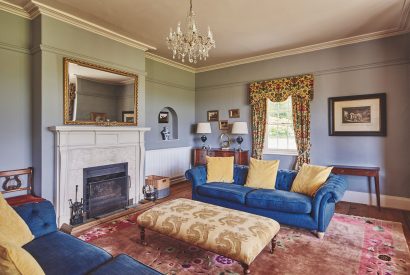 The living room with a fireplace at Equestrian Manor, Malvern Hills