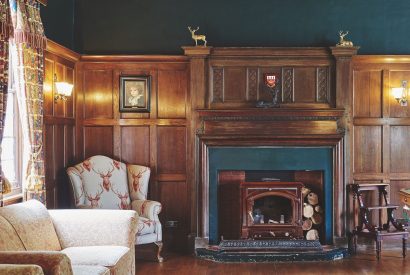 A games room with fireplace at Equestrian Manor, Malvern Hills