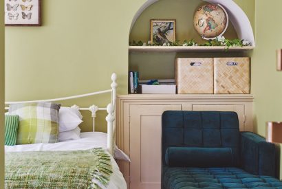 A bedroom with sofa at Equestrian Manor, Malvern Hills