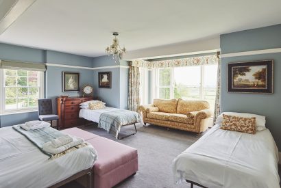 A large bedroom with sofa at Equestrian Manor, Malvern Hills