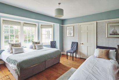 A large bedroom with bay window at Equestrian Manor, Malvern Hills