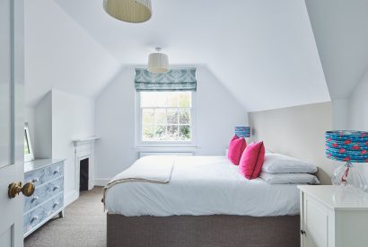 A bedroom with a fireplace at Hidden Hayloft, Malvern Hills