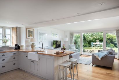 The kitchen and living room with door onto the garden at Hempston Cottage, Devon