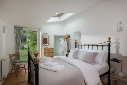A double bedroom with a garden view at Hempston Cottage, Devon