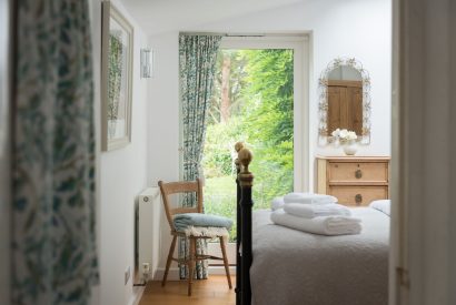 A bedroom overlooking the garden at Hempston Cottage, Devon