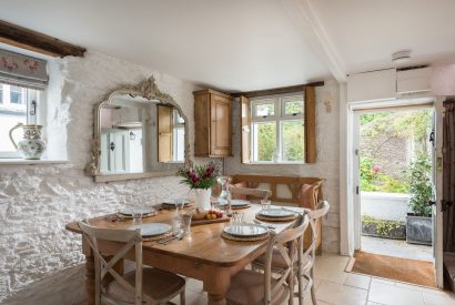 The dining room with access to the front garden at Hempston Cottage, Devon
