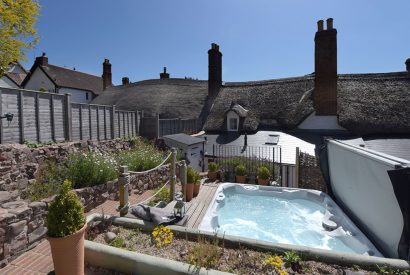 The tiered garden with a hot tub at Sweet Shop Cottage, Somerset