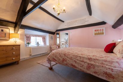 A double bedroom with beams at Sweet Shop Cottage, Somerset
